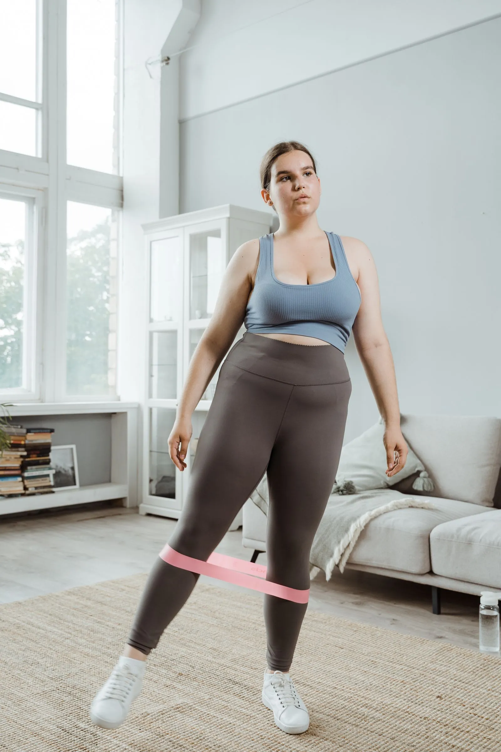A person doing a resistance-band row to strengthen the upper back