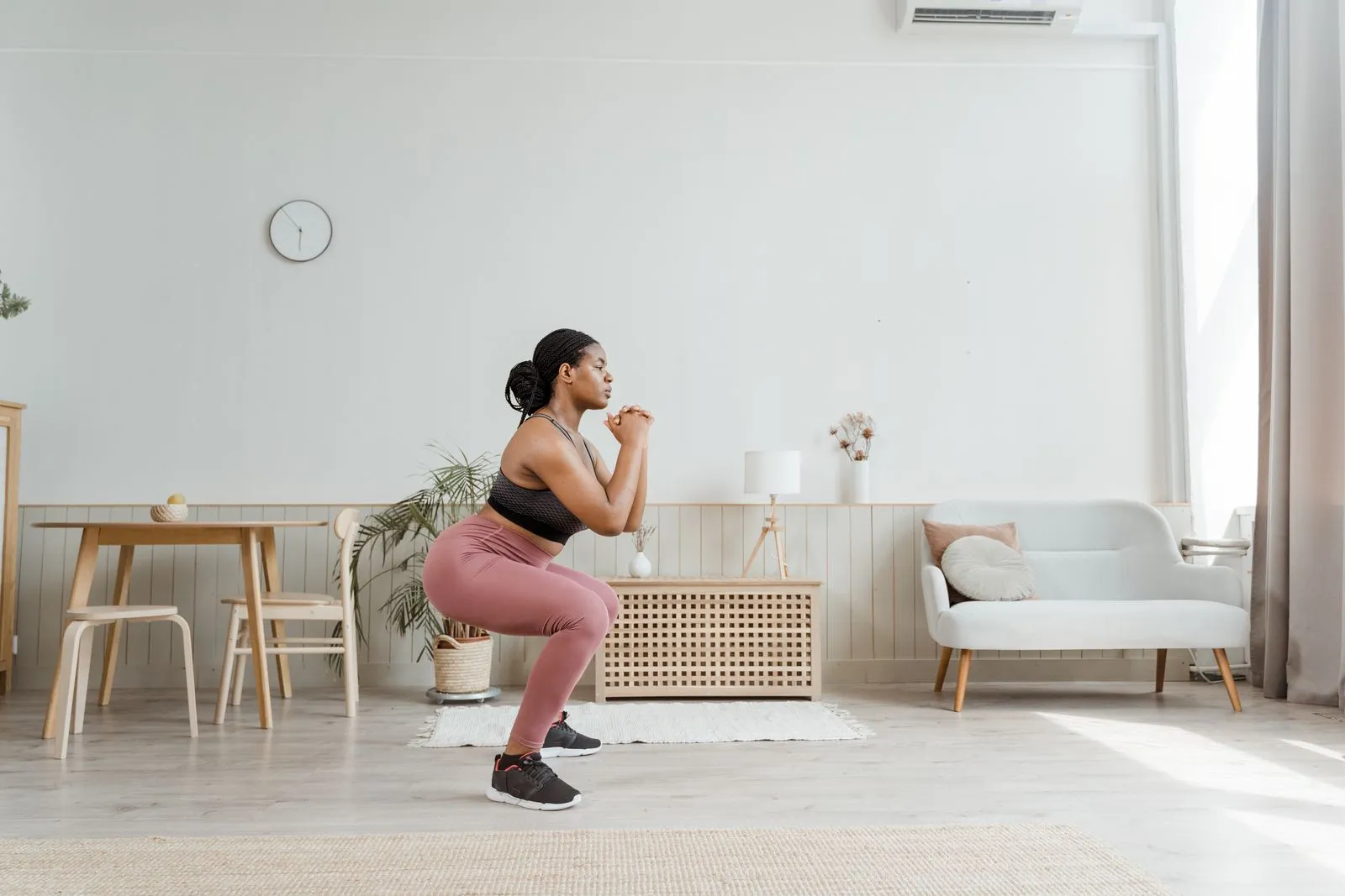 A person doing a bodyweight squat during a short home workout