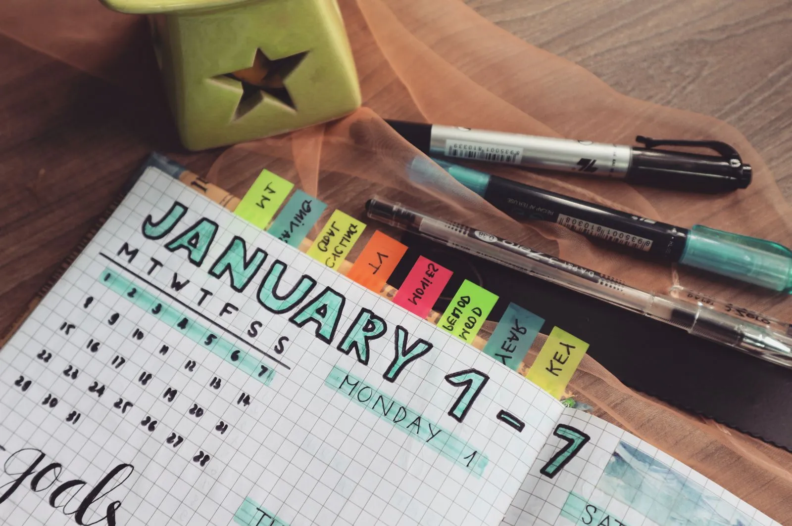 A person planning a workout schedule in a notebook